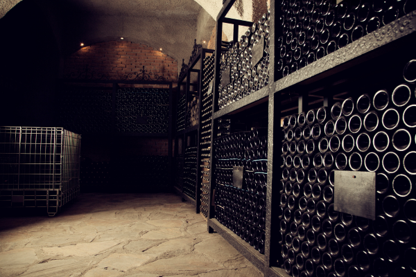 wine cellar full on black glass bottles on their sides